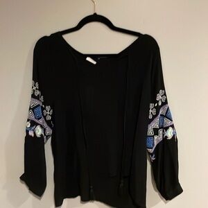 Size small black top with embroidered sleeve.